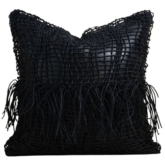 Black geometric cushion cover with textured woven design on sofa