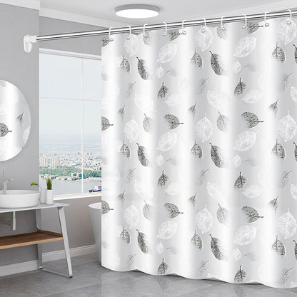 Geometric abstract PEVA shower curtain hanging in a modern white bathroom over a bathtub
