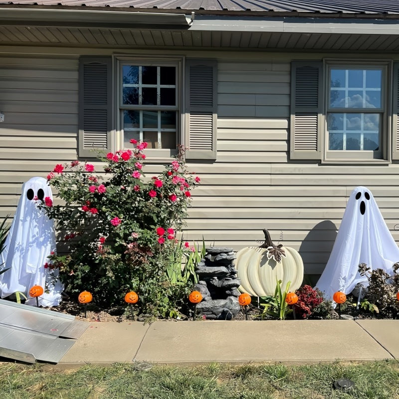 Ghost Halloween decoration placed in front house yard daytime setting