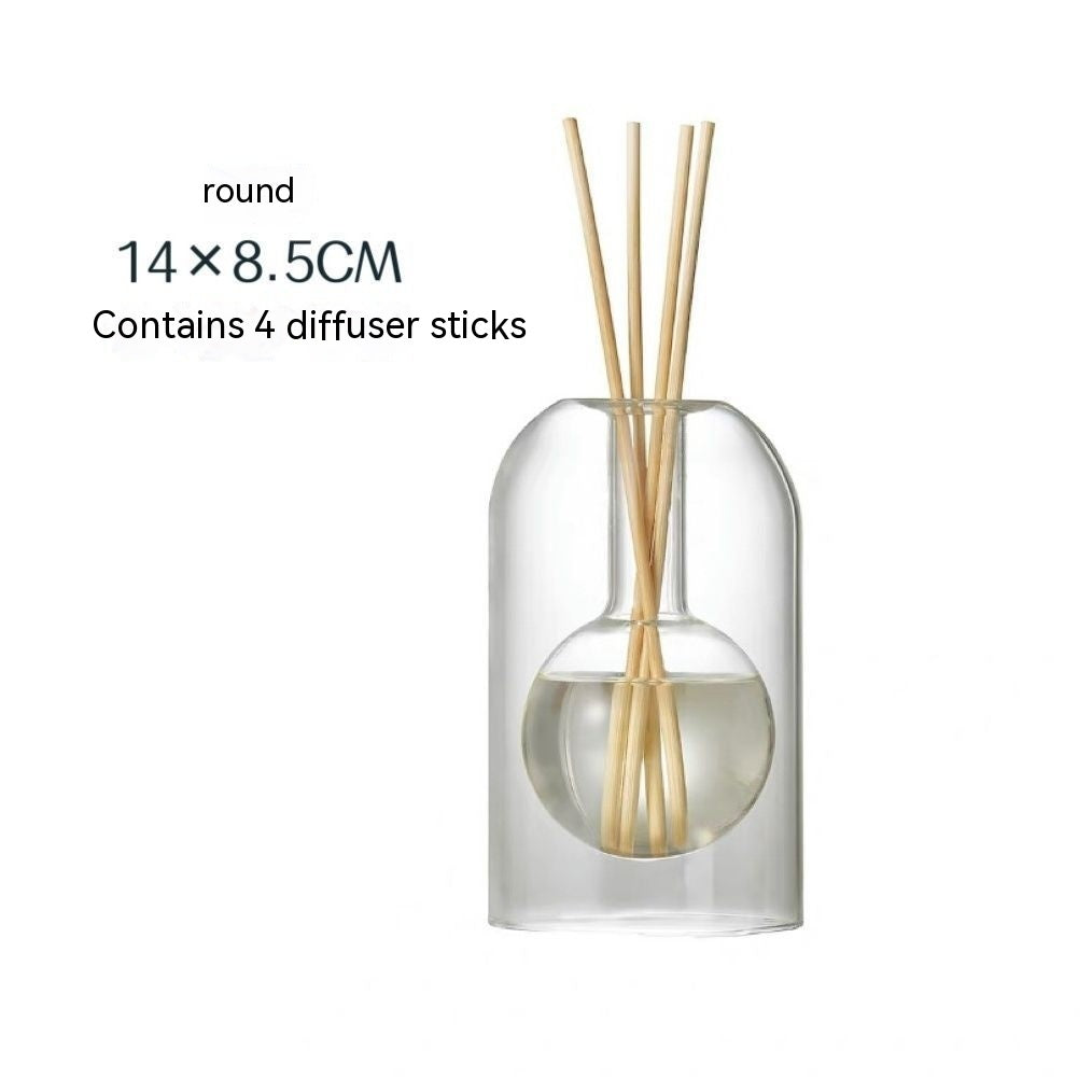 Clear glass diffuser bottle with wooden sticks on a white background