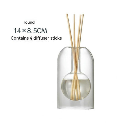Clear glass diffuser bottle with wooden sticks on a white background
