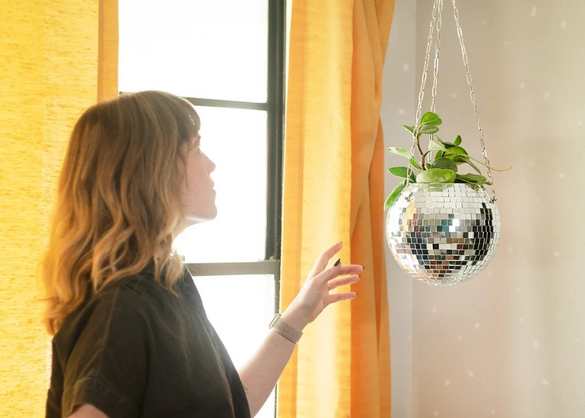 Gold hanging mirror ball flowerpot with trailing plant