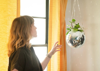 Gold hanging mirror ball flowerpot with trailing plant