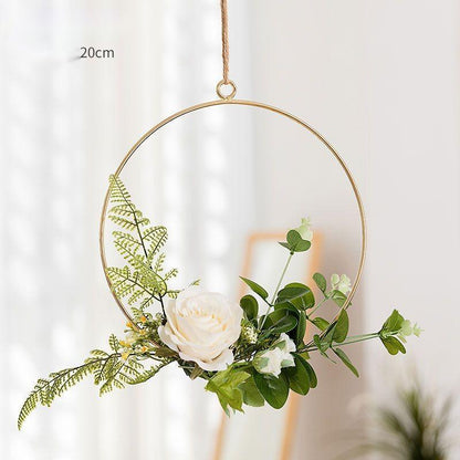 Iron and artificial flower wall art above an entryway console table as a first impression piece
