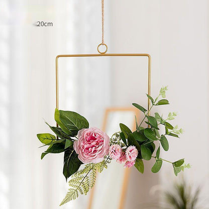 Handmade iron wall hanging with artificial flowers in a home entryway hallway
