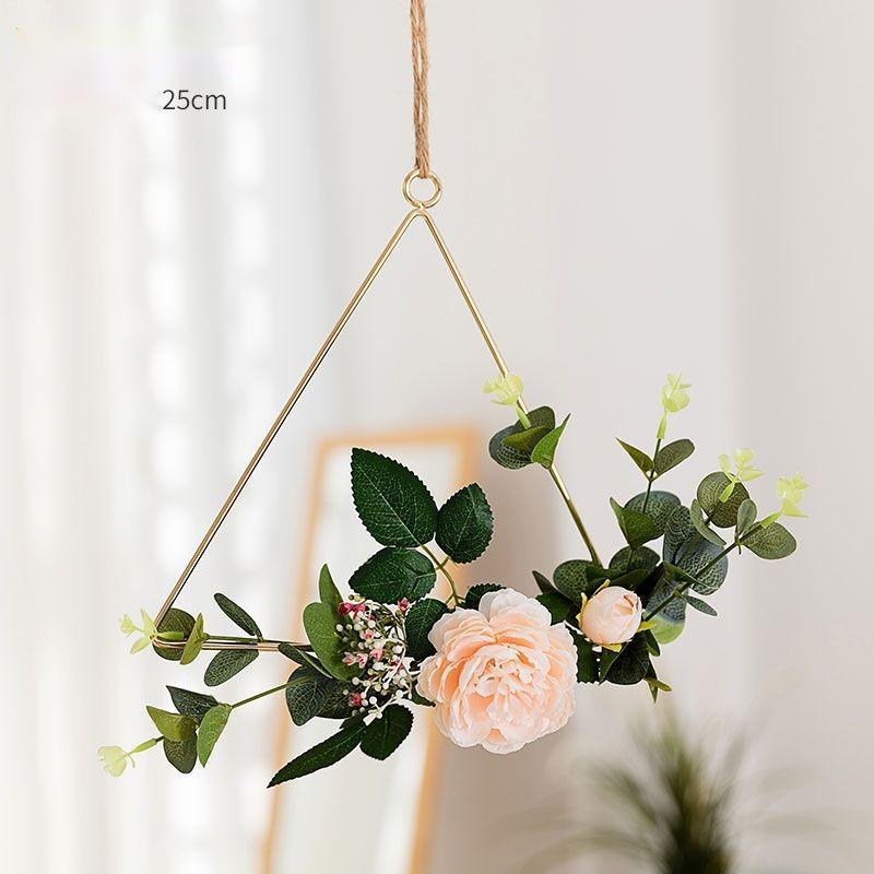 Iron flower wall hanging shown flat against a white wall with no gap between piece and surface
