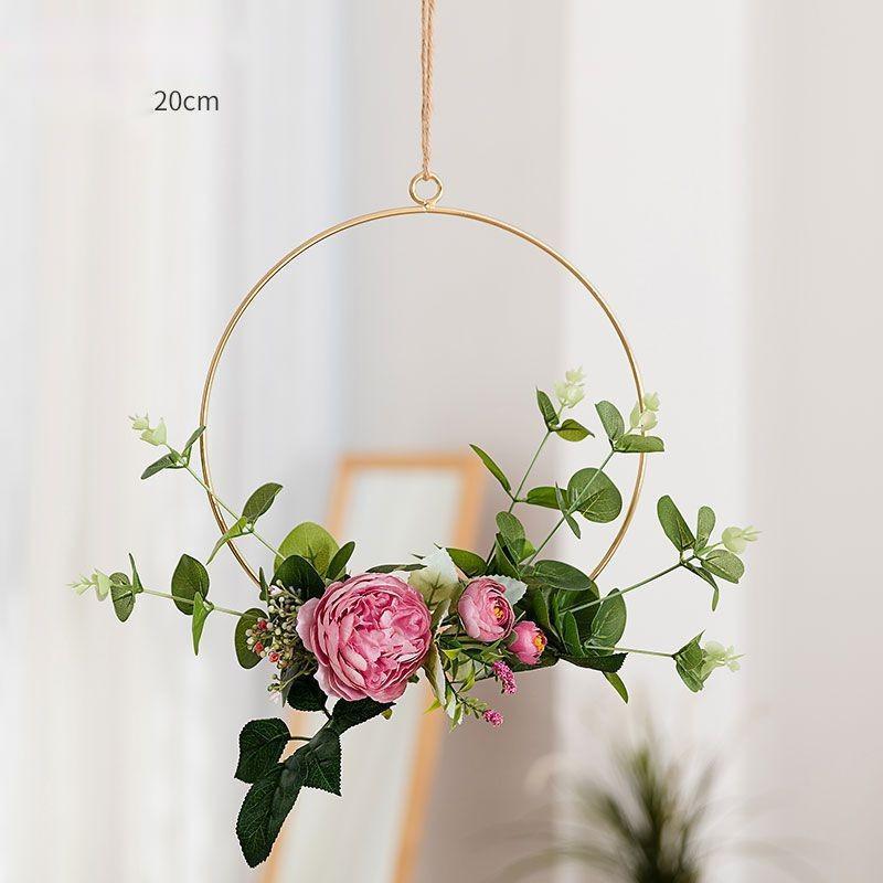 Morning light hitting the iron wall hanging showing texture and depth of the flower arrangement
