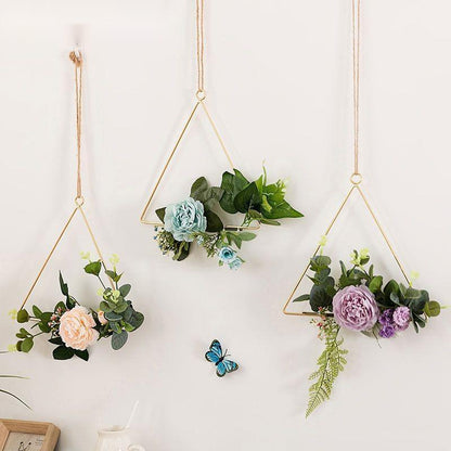 Iron wall hanging with artificial flowers looking the same after months with no watering needed
