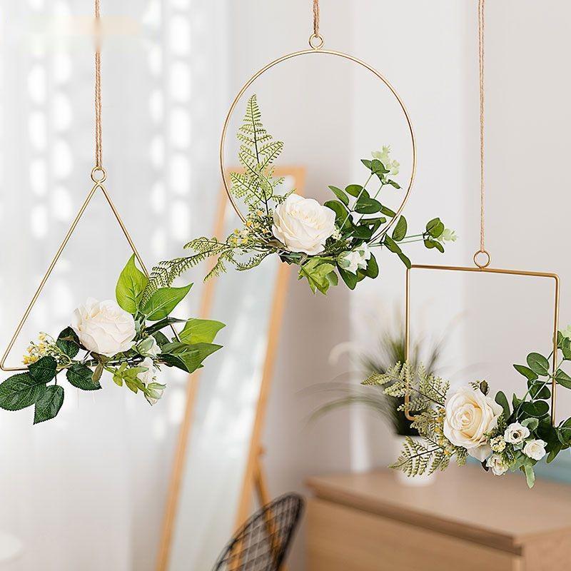Handmade iron flower wall hanging on the wall beside a television in a living room
