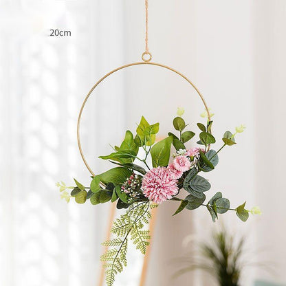 Two iron wall hangings side by side showing natural variation in flower placement between pieces
