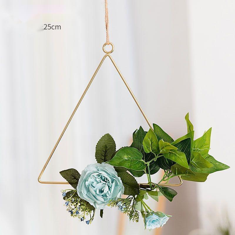 Iron wall hanging with artificial flowers styled in a vintage decorated living room
