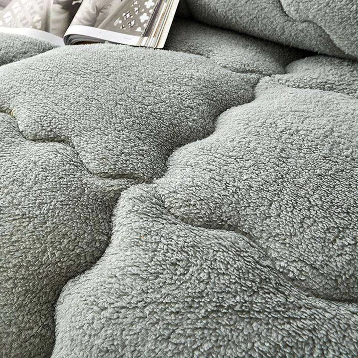 Lamb wool touch microfiber quilt folded on bed