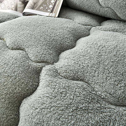 Lamb wool touch microfiber quilt folded on bed
