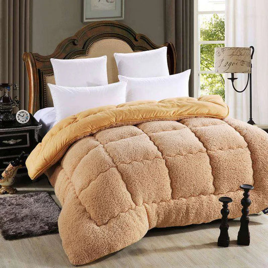 Lamb wool touch microfiber quilt in camel color on bed