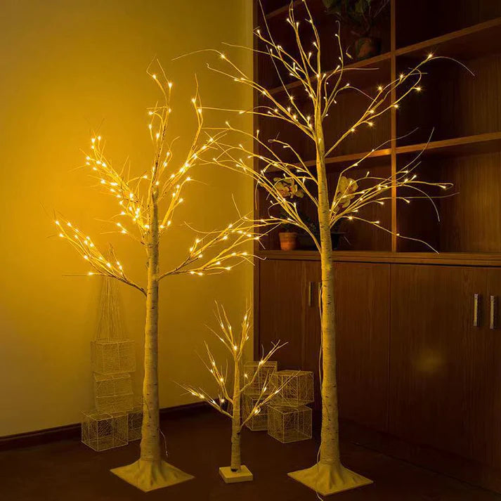 LED birch tree lights glowing warmly in living room corner
