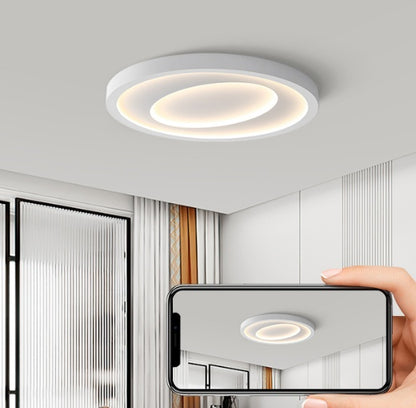 Person using voice command to control the LED ceiling light from bed in a modern bedroom
