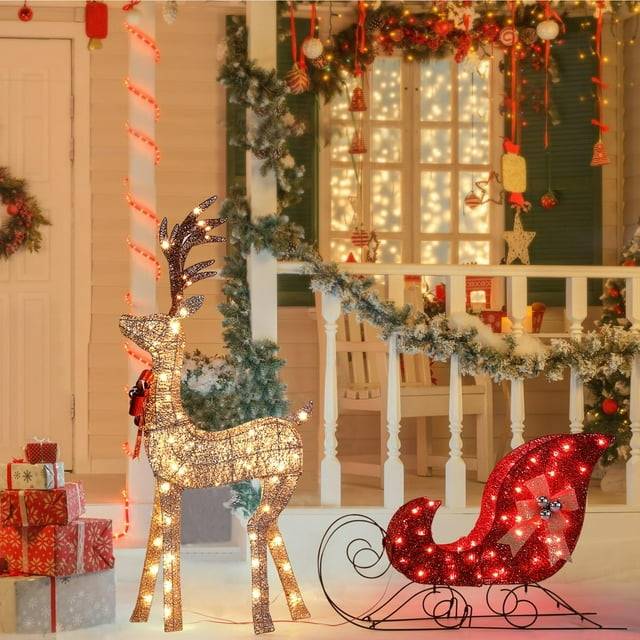 Lighted Christmas deer yard decor with sleigh at night