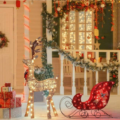 Lighted Christmas deer yard decor with sleigh at night