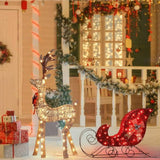 Lighted Christmas deer yard decor with sleigh at night