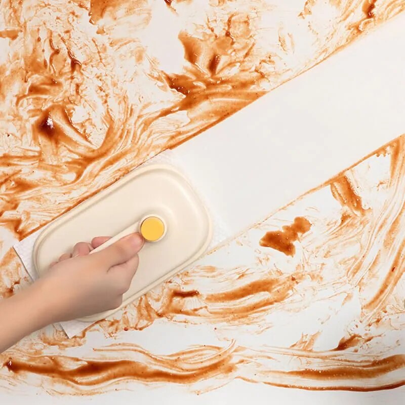 Magic brush being used to clean kitchen cabinet surface