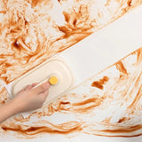 Magic brush being used to clean kitchen cabinet surface