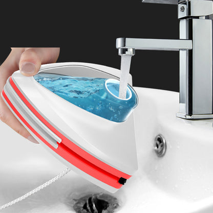 Red double sided magnetic window cleaner on glass