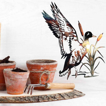 Mallard trout metal wall art near potted plant setting