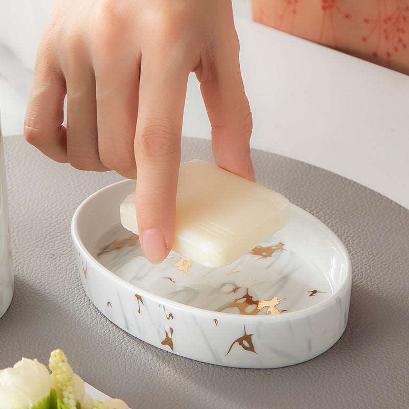 White marble soap dish and gold accent tray