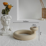 Nordic matte ceramic vase with dried botanicals on a bedside table beside a lamp