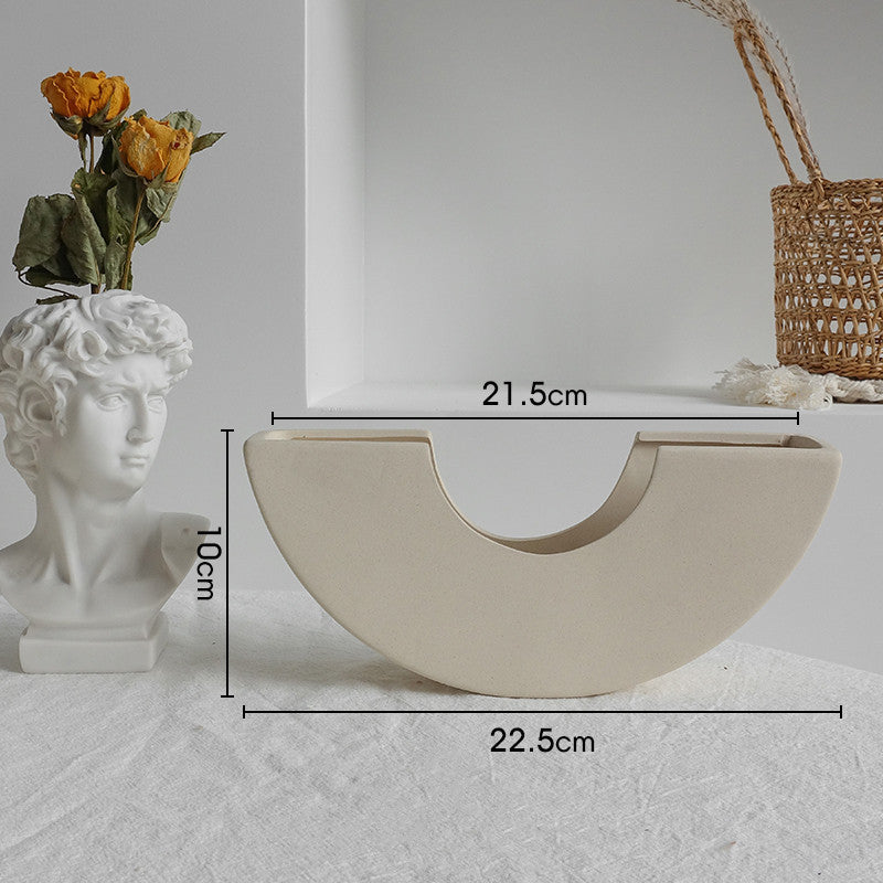 Matte ceramic vase on an entryway console table with dried stems as a home decor accent
