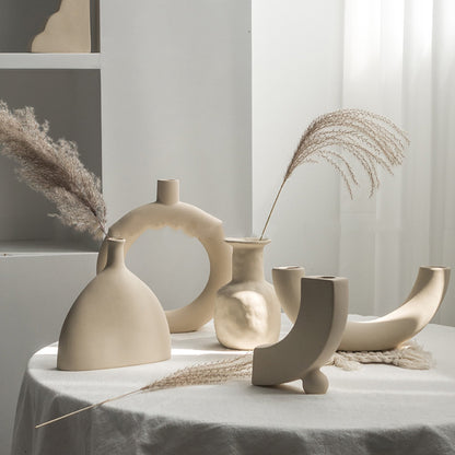 Matte ceramic vase holding pampas grass on a wooden shelf in a Nordic minimalist living room
