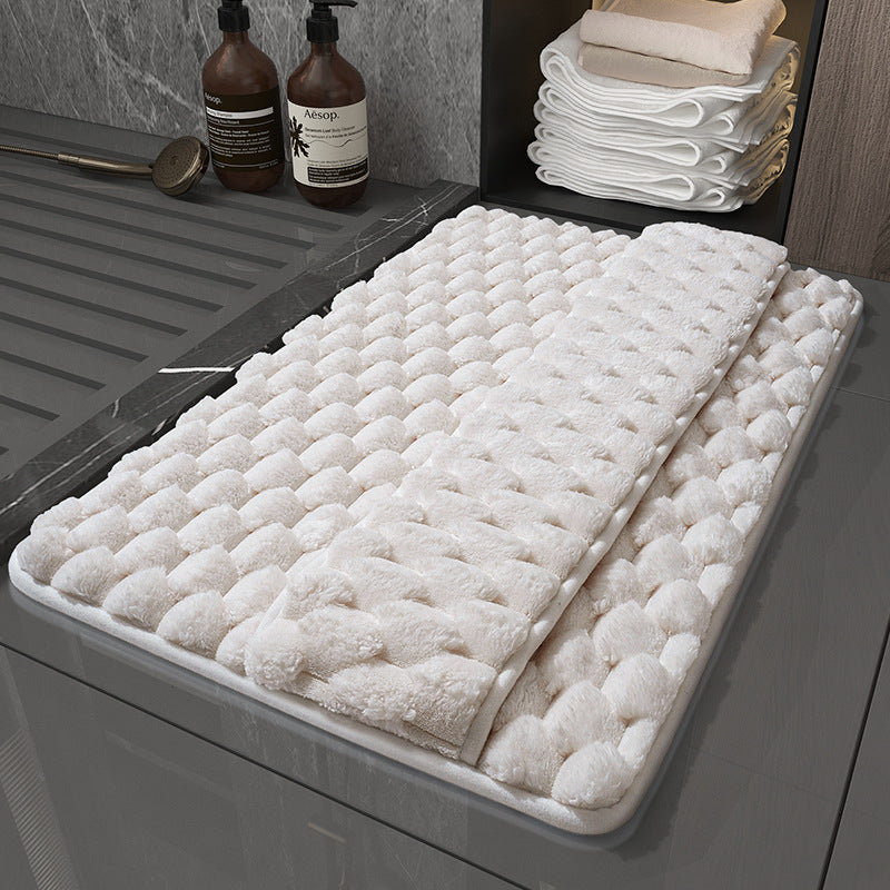 Wet feet stepping on the memory foam bathroom mat showing fast water absorption on surface
