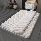 Wet feet stepping on the memory foam bathroom mat showing fast water absorption on surface
