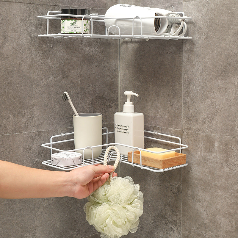 Hand installing metal corner shower caddy without drilling