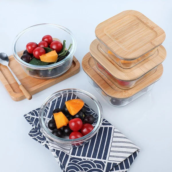 Microwave safe bento box with compartments filled with food on wooden surface