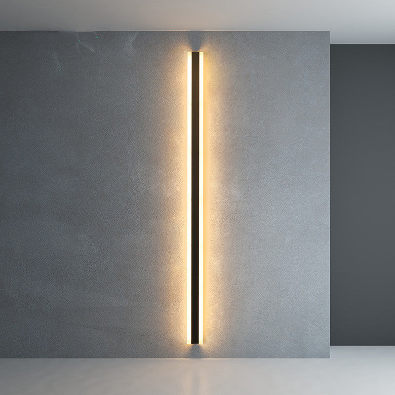 Minimalist LED wall lamp glowing in dark room