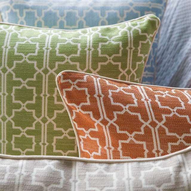 Sky blue Moroccan trellis throw pillow on bed