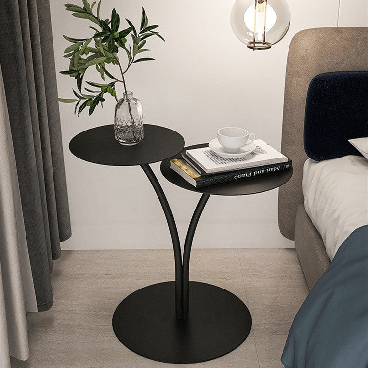 Nordic small round metal sofa side table beside a sofa in a minimalist living room
