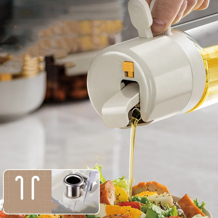 Olive oil sprayer bottle drizzling oil on fresh salad