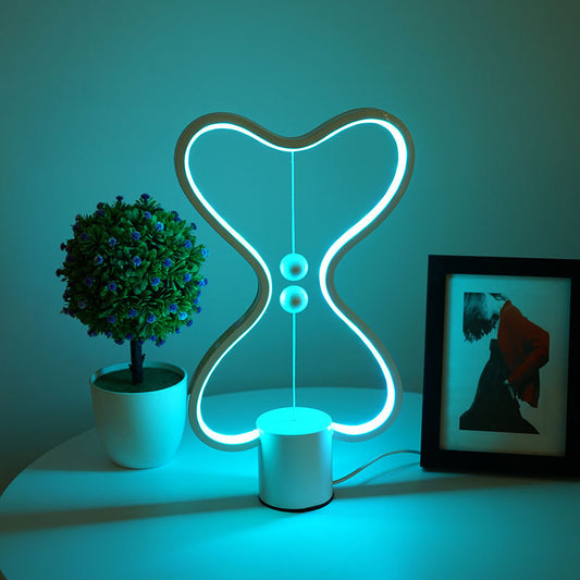 Oval curved frame LED night light standing on a modern office desk decoration