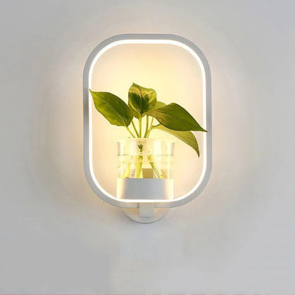 Opened box showing the LED wall light fixture with its mounting hardware included