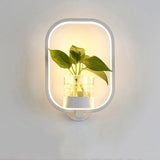 Opened box showing the LED wall light fixture with its mounting hardware included