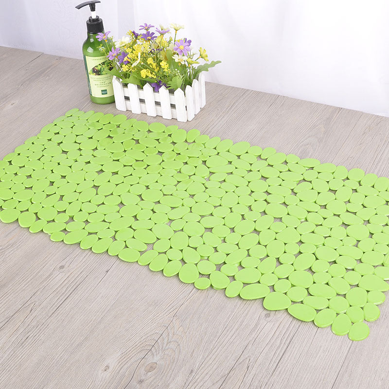 Underside of the pebble PVC bathroom mat showing flat non slip base on tile floor
