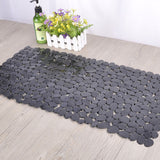 Pebble design PVC non slip bathroom mat lying flat on a wet shower floor
