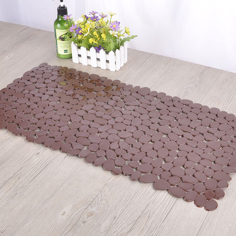 Pebble PVC mat gripping wet tile floor in a modern bathroom with no sliding movement
