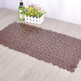 Pebble PVC mat gripping wet tile floor in a modern bathroom with no sliding movement
