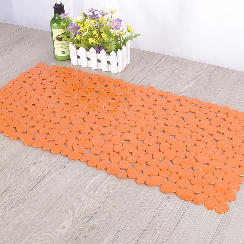 Eco friendly pebble PVC mat covering the standing area inside a standard shower stall

