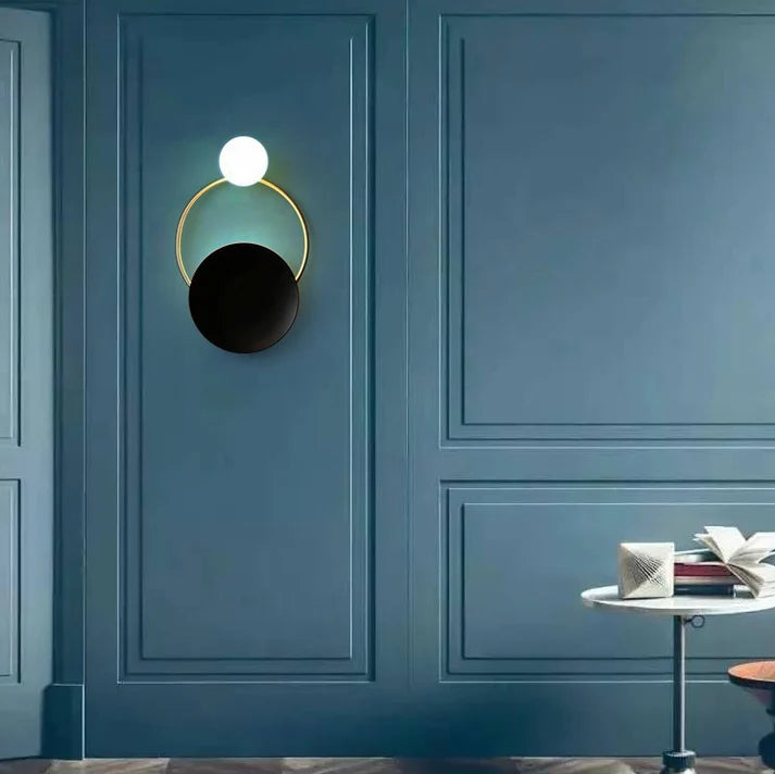 Post modern ring wall lamp warm light on blue wall hallway decor