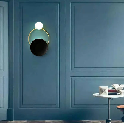Post modern ring wall lamp warm light on blue wall hallway decor