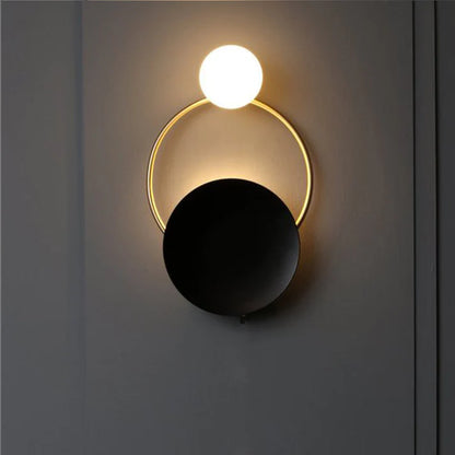 Post modern ring wall lamp warm light on dark wall bedroom setting